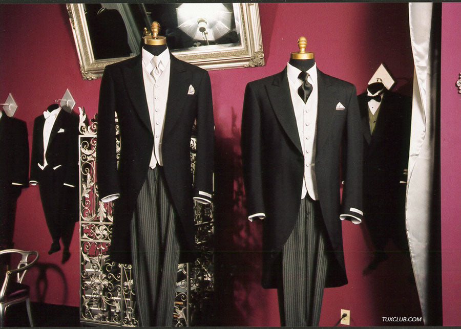 Collection of formal morning suits on mannequins against a red wall with a mirror inside a tuxedo for rental shop