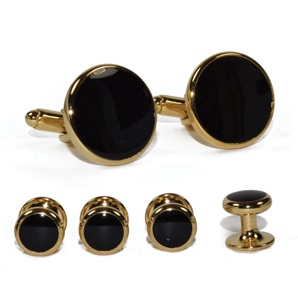 close up black enamel cufflinks and studs in gold setting