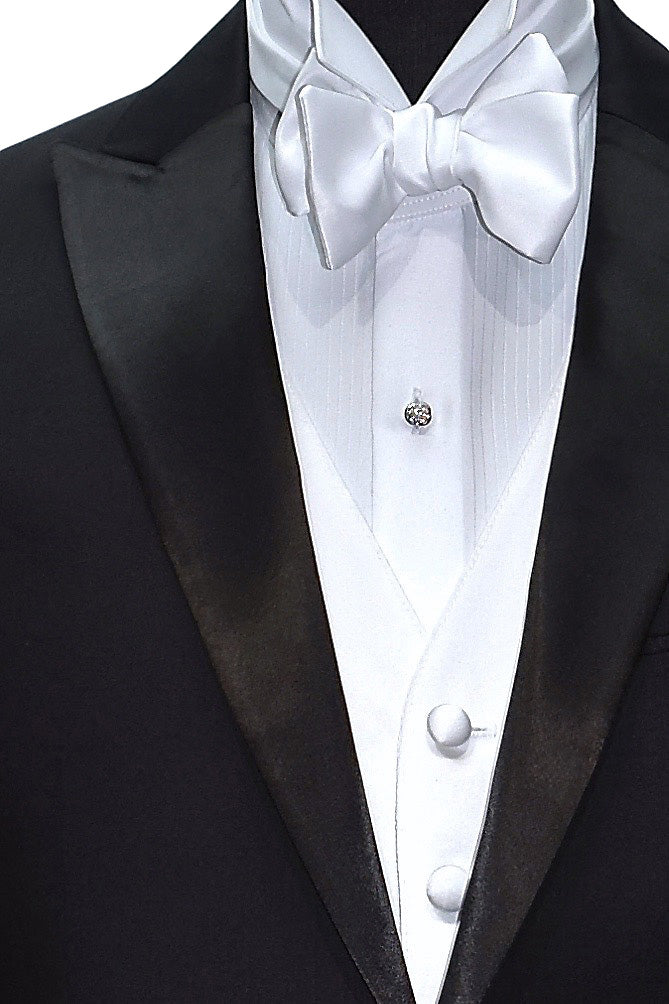 Close-up front view of black peak lapel tuxedo with white satin vest and white "tie-yourself" bowtie.