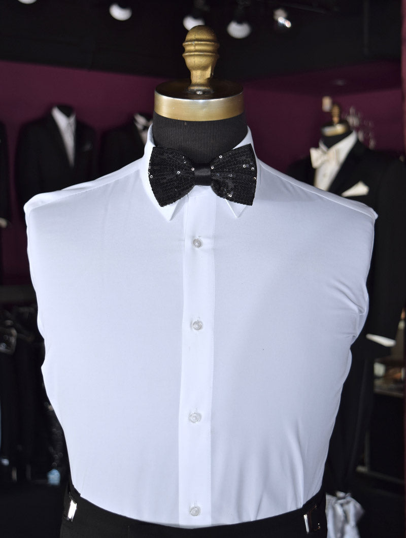 White dress shirt with a black sequin bow tie on a mannequin inside of a tuxedo shop