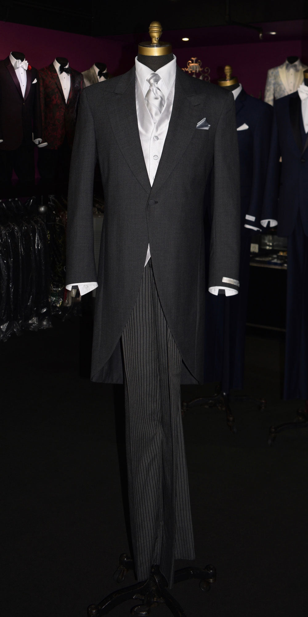 Mannequin wearing a charcoal cutaway morning suit with silver vest and tie at a tuxclub tuxedo shop