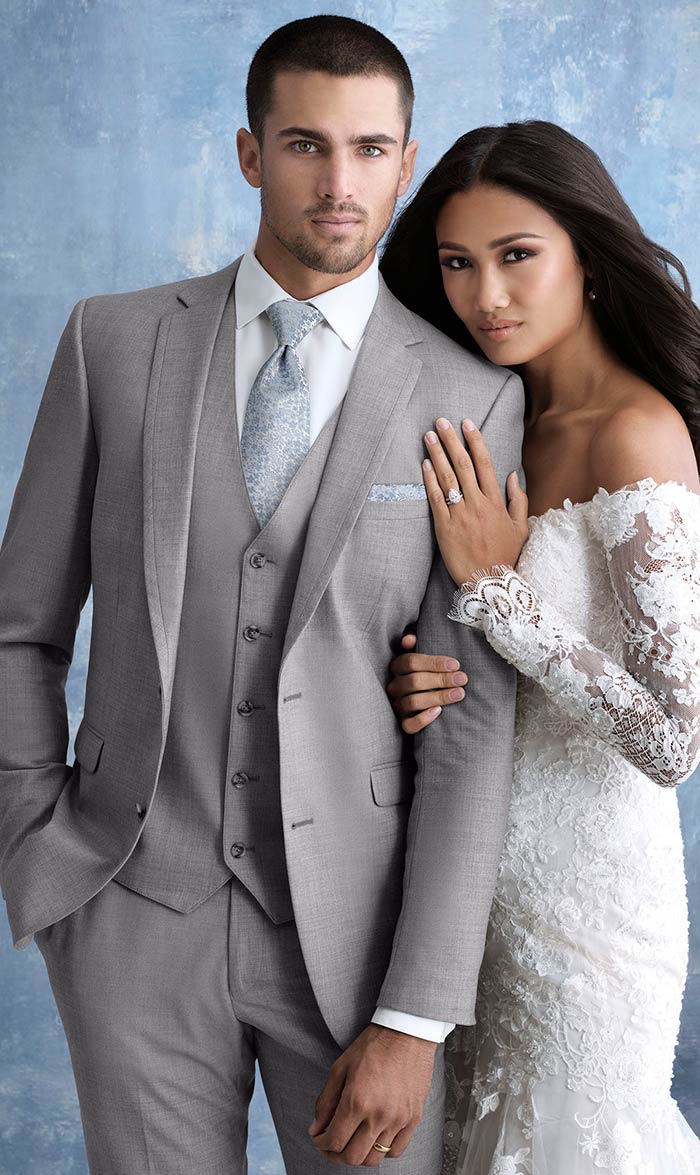 hispanic male model wearing gray men's slim-fit suit and young female hispanic model in a white wedding gown.