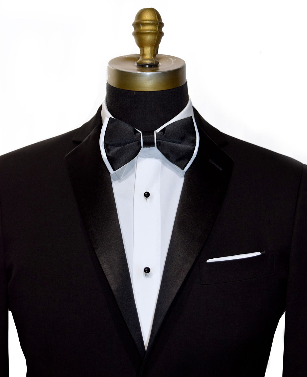Black tuxedo with white shirt and black bow tie with white trim on mannequin against a white background