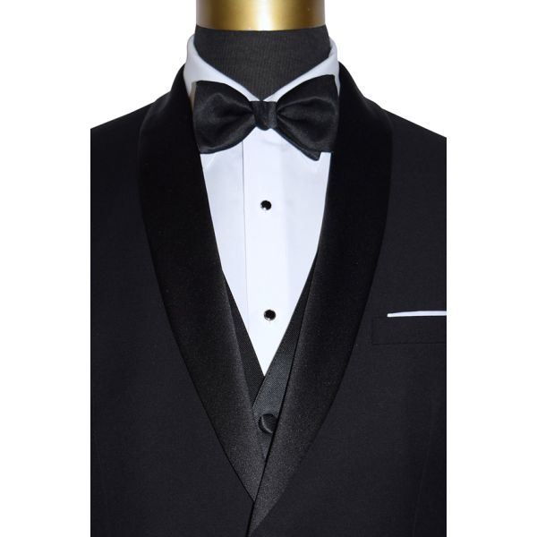 very close-up mannequin wearing a black tuxedo with a white tuxedo shirt and black bowtie with slight texture on a white background