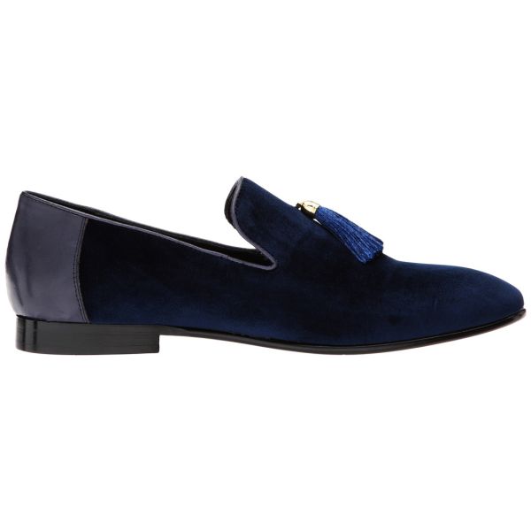close up blue velvet men's slip-on shoes with tassel against a white background