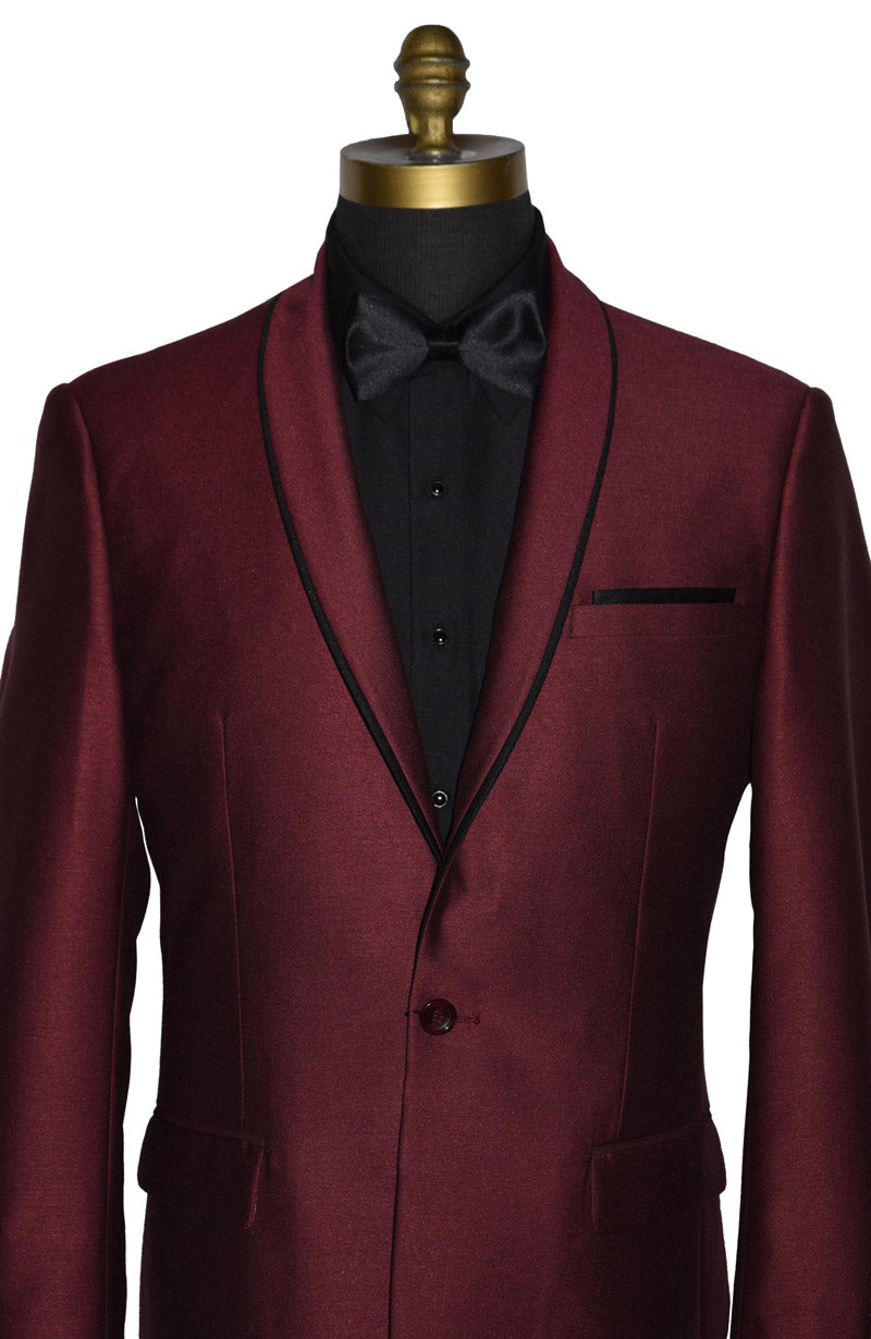 very close up - mannequin wearing a burgundy shawl collar tuxedo with a black shirt and black bow tie against a white background