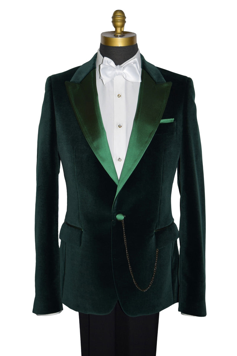 Green velvet tuxedo jacket on a mannequin with a white shirt displaying cubic zirconia studs and cufflinks in gold setting