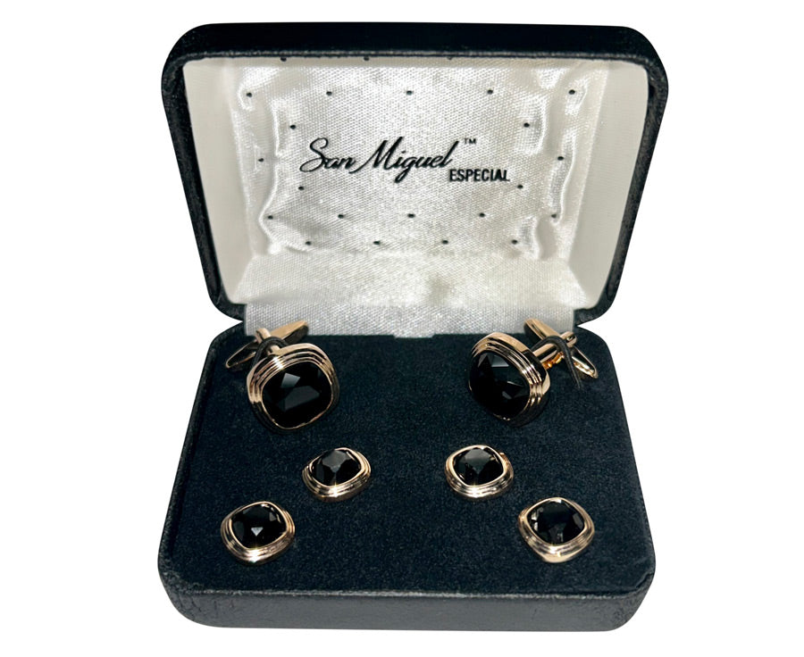 close-up Cufflink and studs set with black stones and rose-gold setting in a 'San Miguel Especial' branded box.