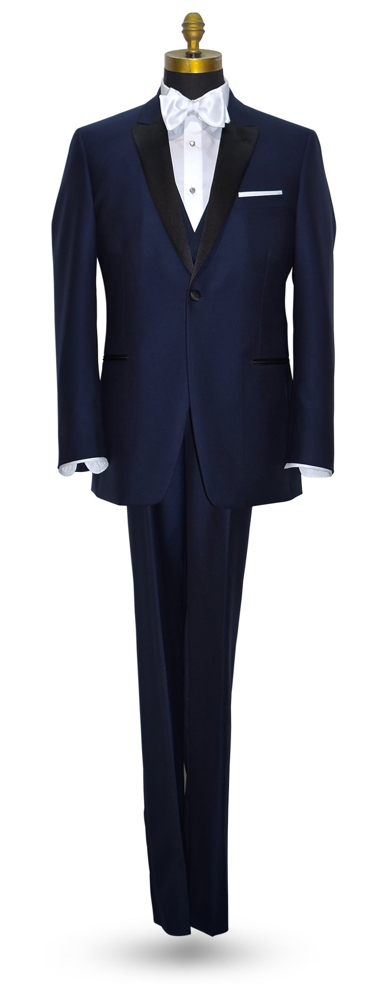 life size mannequin of a Navy-blue peak-lapel tuxedo for rental shown with a navy blue vest and white satin "tie-yourself" bowtie against a white background