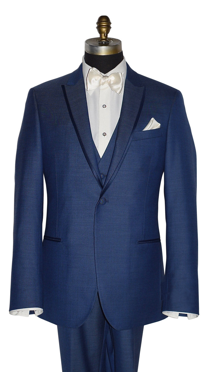 close-up mannequin wearing a "new blue" tuxedo with the matching new-blue tuxedo vest shown here with an ivory dress shirt and an ivory "tie-yourself" bowtie against a white background