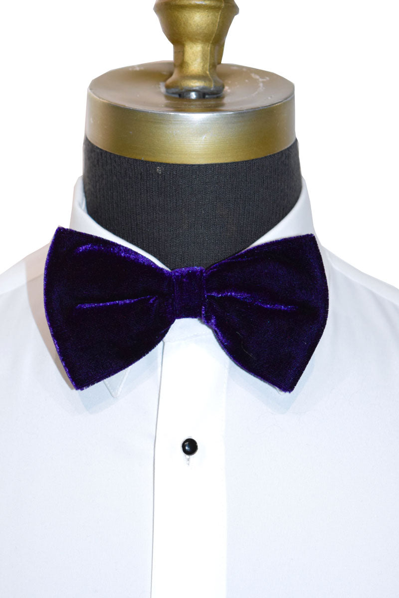 Purple velvet bow tie on a mannequin with a white tuxedo shirt