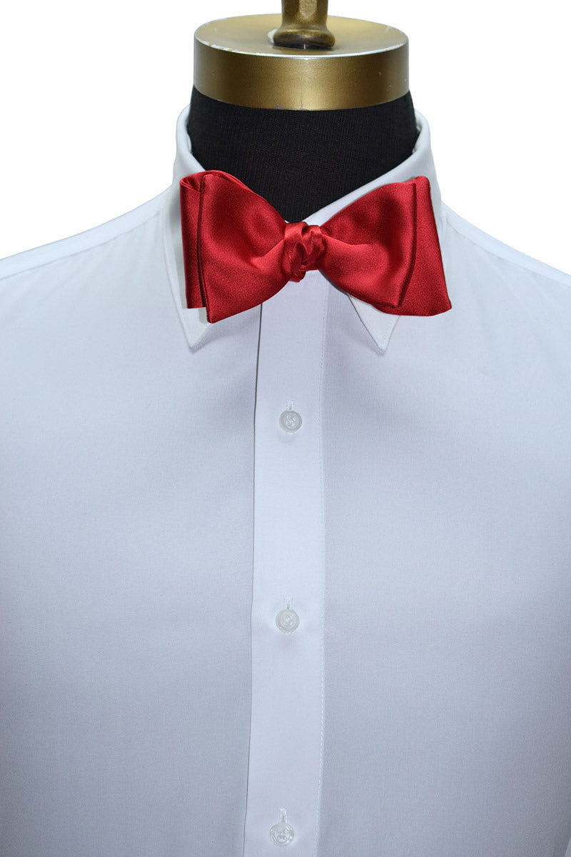 close-up white tuxedo shirt with a red "tie-yourself" satin bow tie.