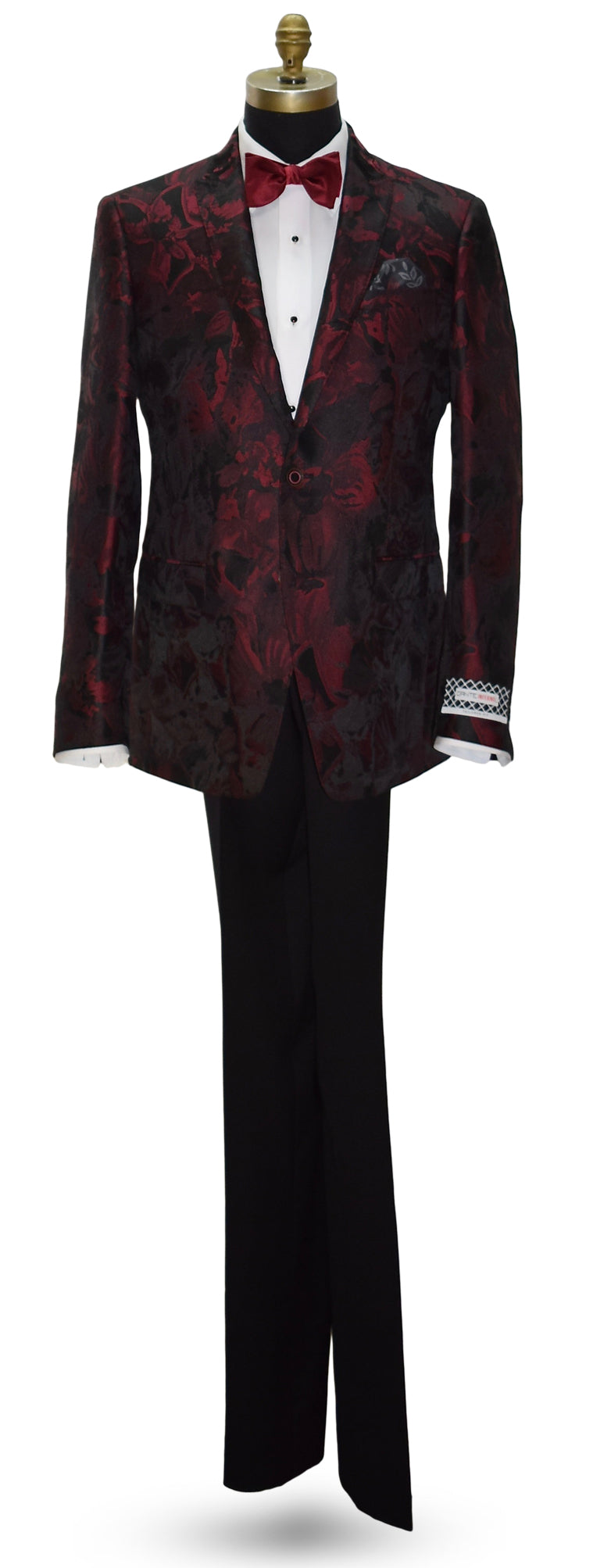 Red patterned dinner jacket with red bowtie and black pants on a mannequin against a white background