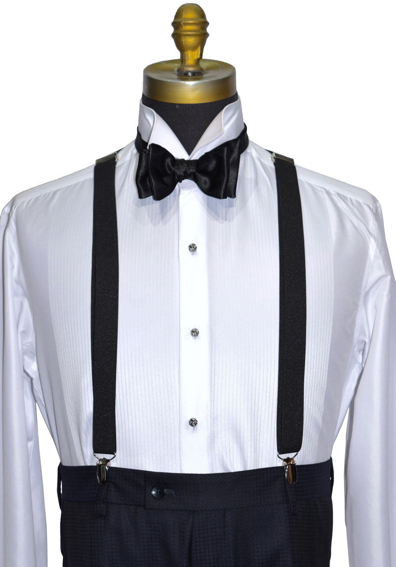 Mannequin wearing a white dress shirt with silver "love knot" studs and cufflinks with black suspenders and bow tie on a white background