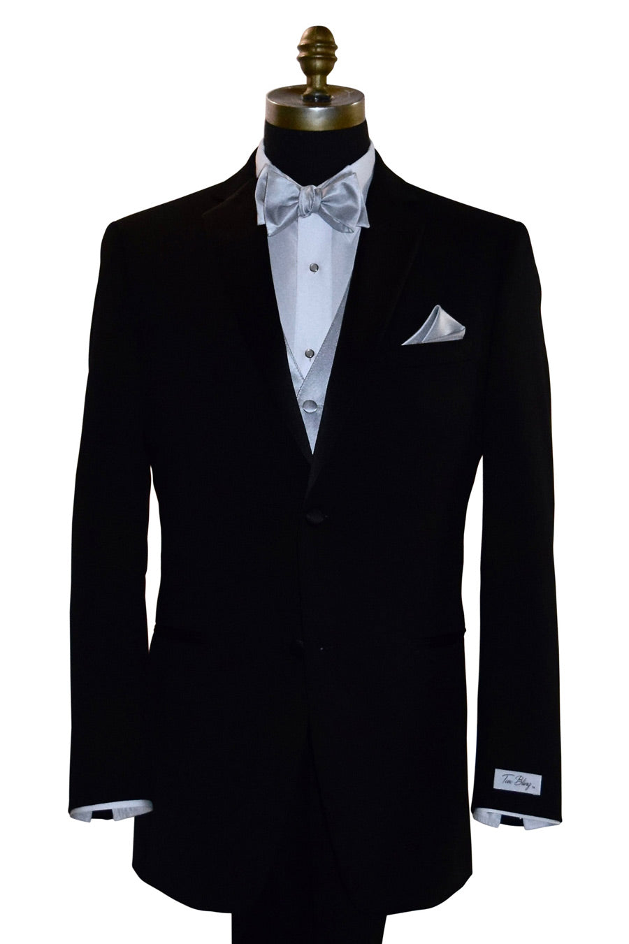 mannequin wearing a black tuxedo with a white tuxedo shirt and a silver tuxedo vest with a silver "tie-yourself" bowtie and pocket handkerchief against a white background