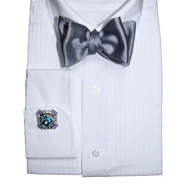 close-up silver satin bowtie on display with a white tuxedo shirt against a white background