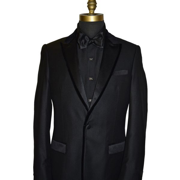 mannequin wearing "skull and bones" cufflinks and studs on a black tuxedo with a black tuxedo shirt and black bowtie