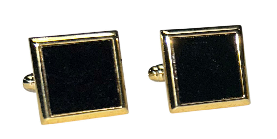 Square cufflinks with black onyx centers and gold borders on a white background