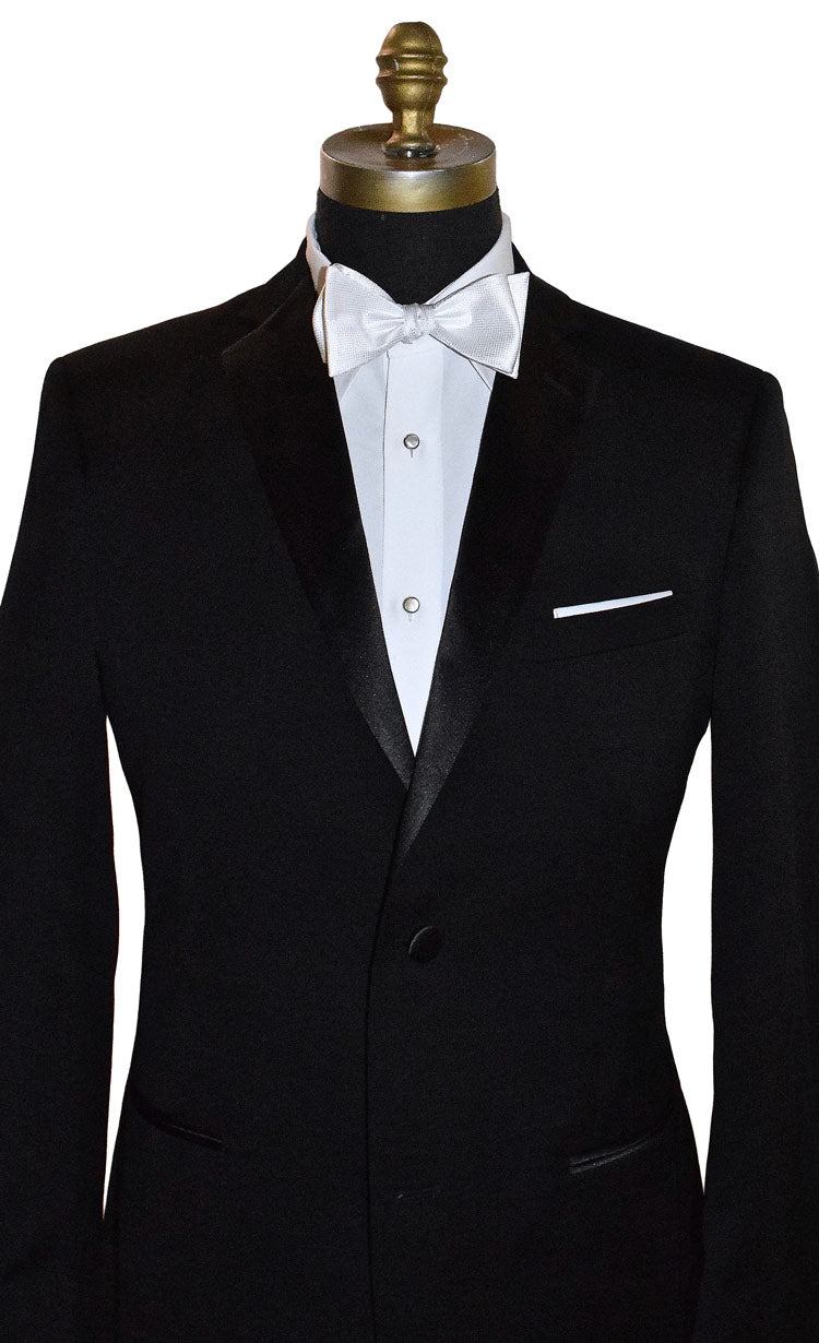 Black tuxedo with white pique bow tie on a mannequin against a white background