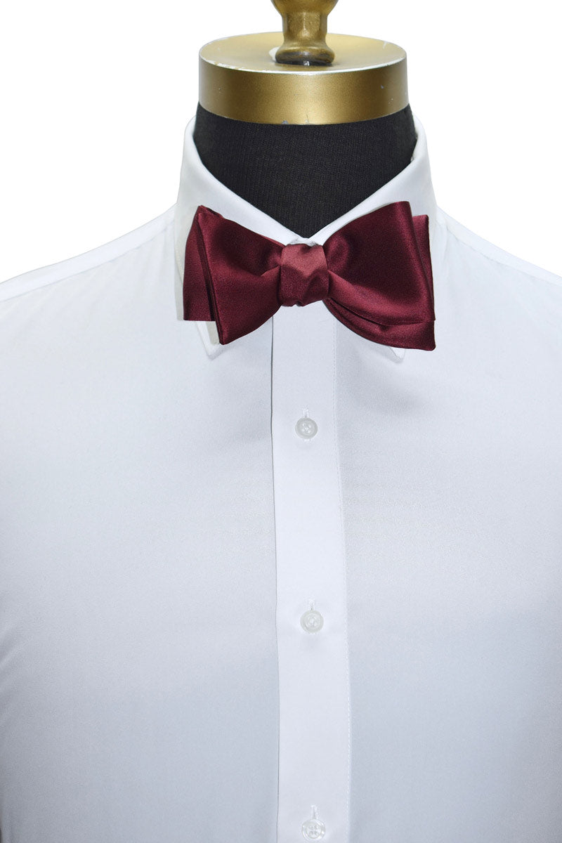 White dress shirt with a burgundy "tie-yourself" bow tie on a mannequin against a white background