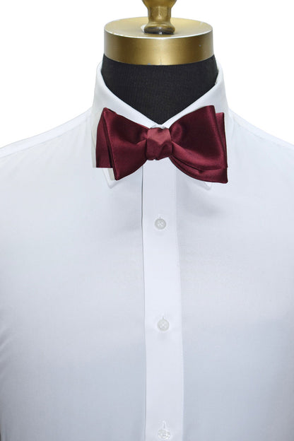 White dress shirt with a burgundy "tie-yourself" bow tie on a mannequin against a white background
