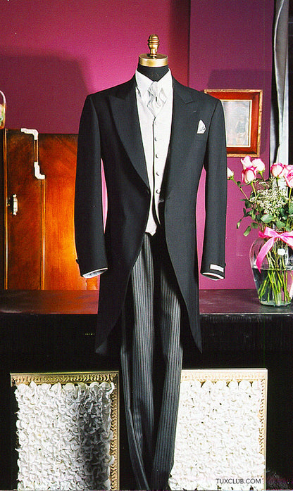 full length mannequin wearing a Charcoal cutaway morning suit with silver dress tie and vest with striped pants in a tuxedo shop