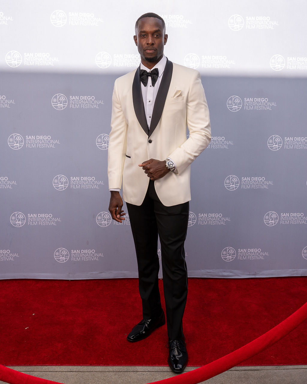 Close up man wearing an ivory tuxedo with black shawl collar at the San Diego film festival in La Jolla California