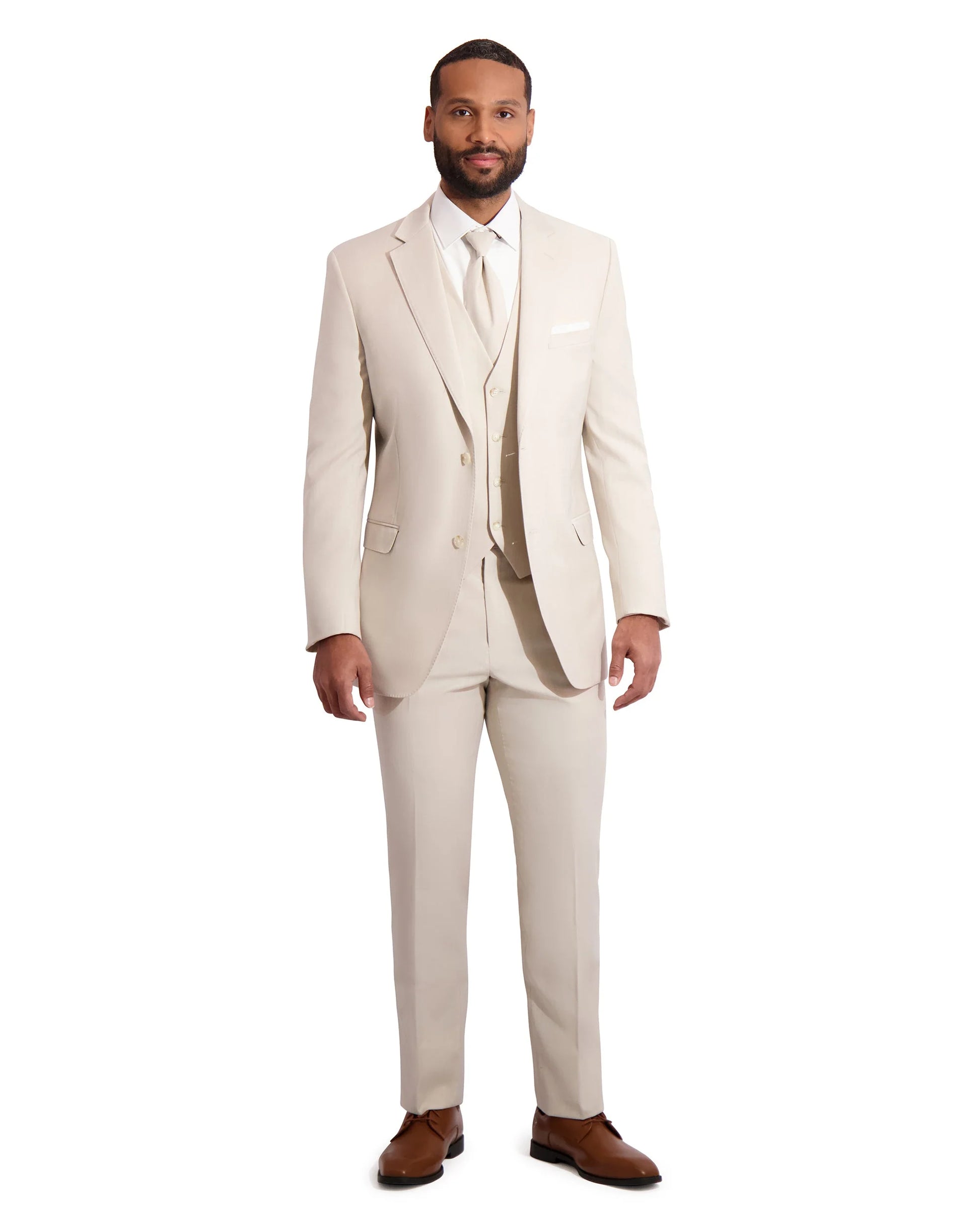 front view of black model wearing a tan slim-fit wedding suit standing in front of white background