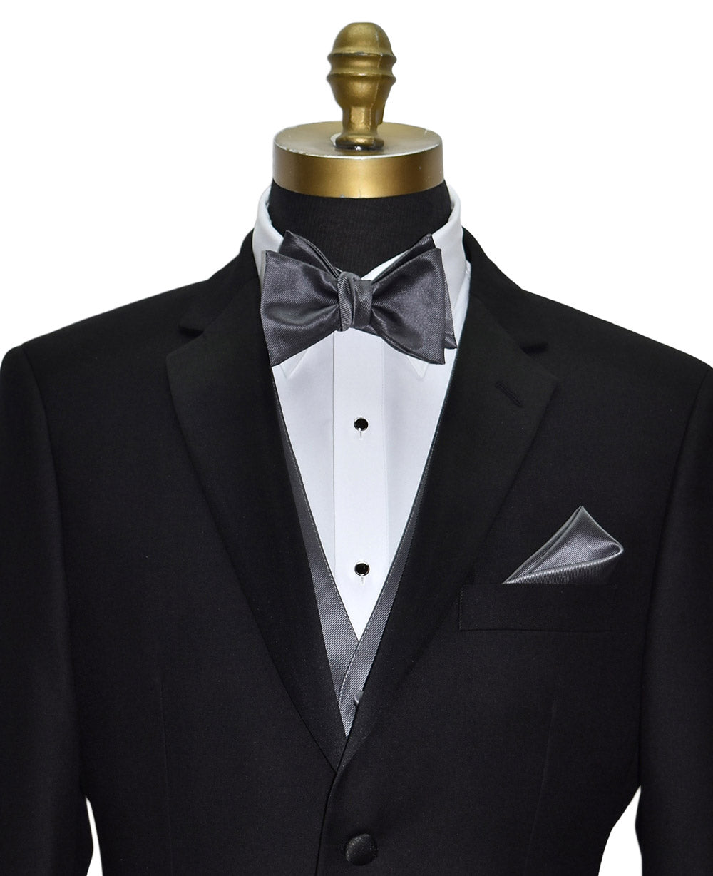 close-up front view Black tuxedo with a charcoal "tie-yourself"  bow tie on a mannequin against a white background