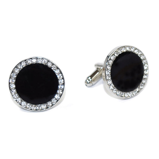 Black cufflinks with silver circular designs with cubic zirconia crystals on a white background