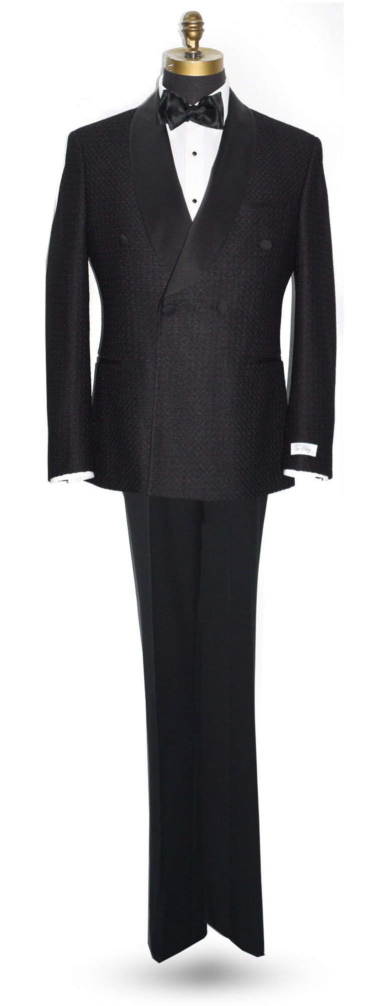 life size mannequin wearing a black double-breasted shawl collar tuxedo with a black bow tie against a white background 