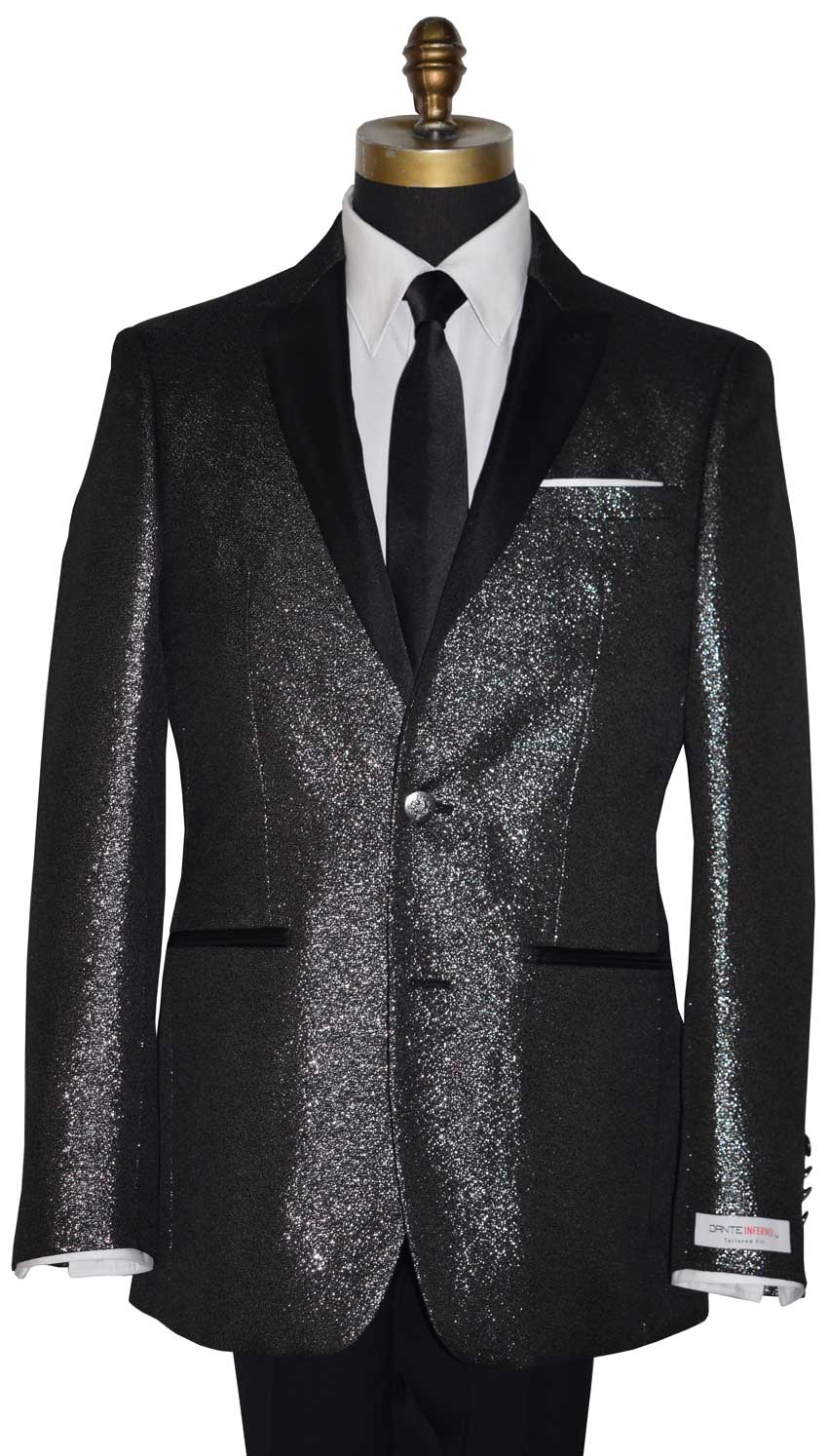 close-up full length mannequin wearing a black peak lapel tuxedo with shimmer accessorized with long black skinny dress tie with a "Dante Inferno" branded label on the sleeve against a white background