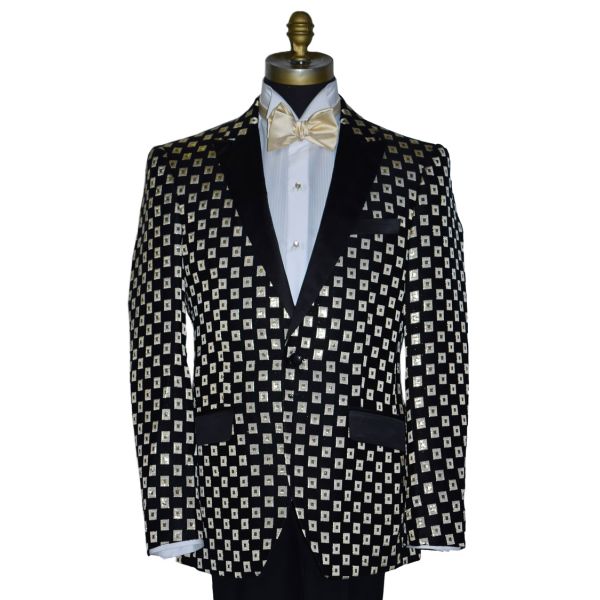 close-up Black with ivory and gold squares pattern tuxedo jacket with a white shirt and gold bow tie on a mannequin against a white background.
