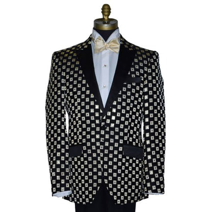 close-up Black with ivory and gold squares pattern tuxedo jacket with a white shirt and gold bow tie on a mannequin against a white background.
