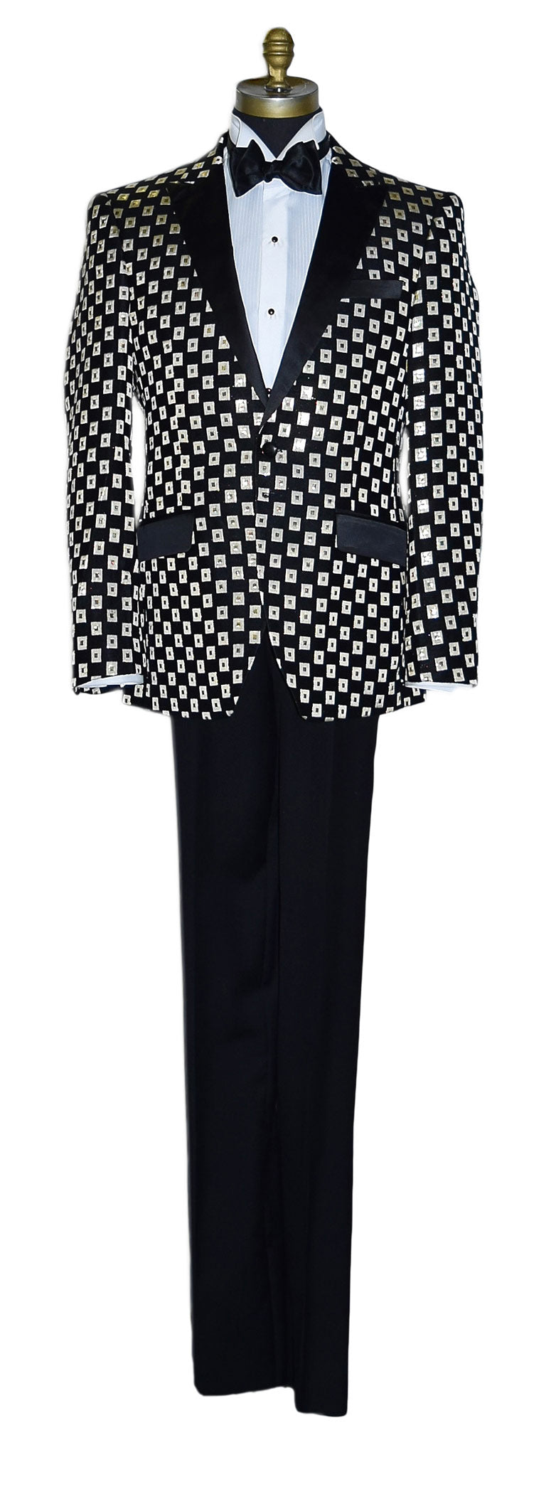 life size mannequin wearing a black and gold tuxedo with a black bowtie against a white background