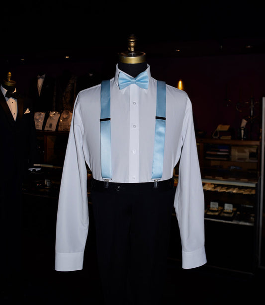 Mannequin wearing a white dress shirt with capri-blue satin suspenders and a capri-blue satin blue bow-tie in a tuxedo shop.