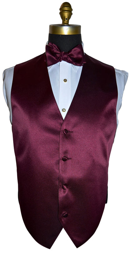 mannequin wearing a white tuxedo shirt with a wine tuxedo vest and wine bowtie against a white background