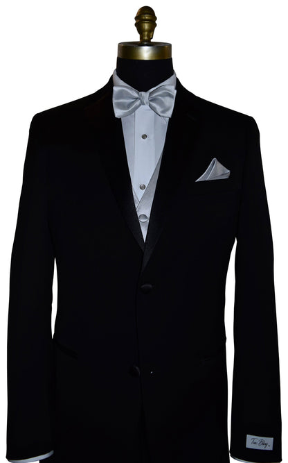 Black tuxedo with white shirt, silver vest and bow tie, and pocket square on a mannequin.