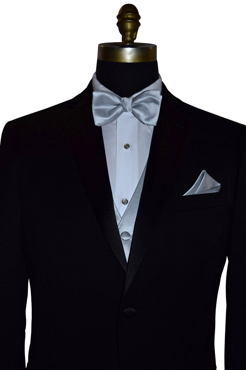 Black tuxedo with white shirt and silver bow tie and silver tuxedo vest on a mannequin against a white background