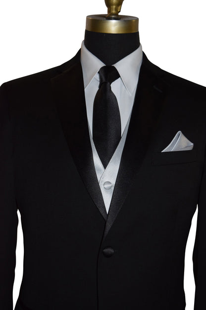 Black wedding suit with white shirt and black necktie with a silver vest on a mannequin against a white background