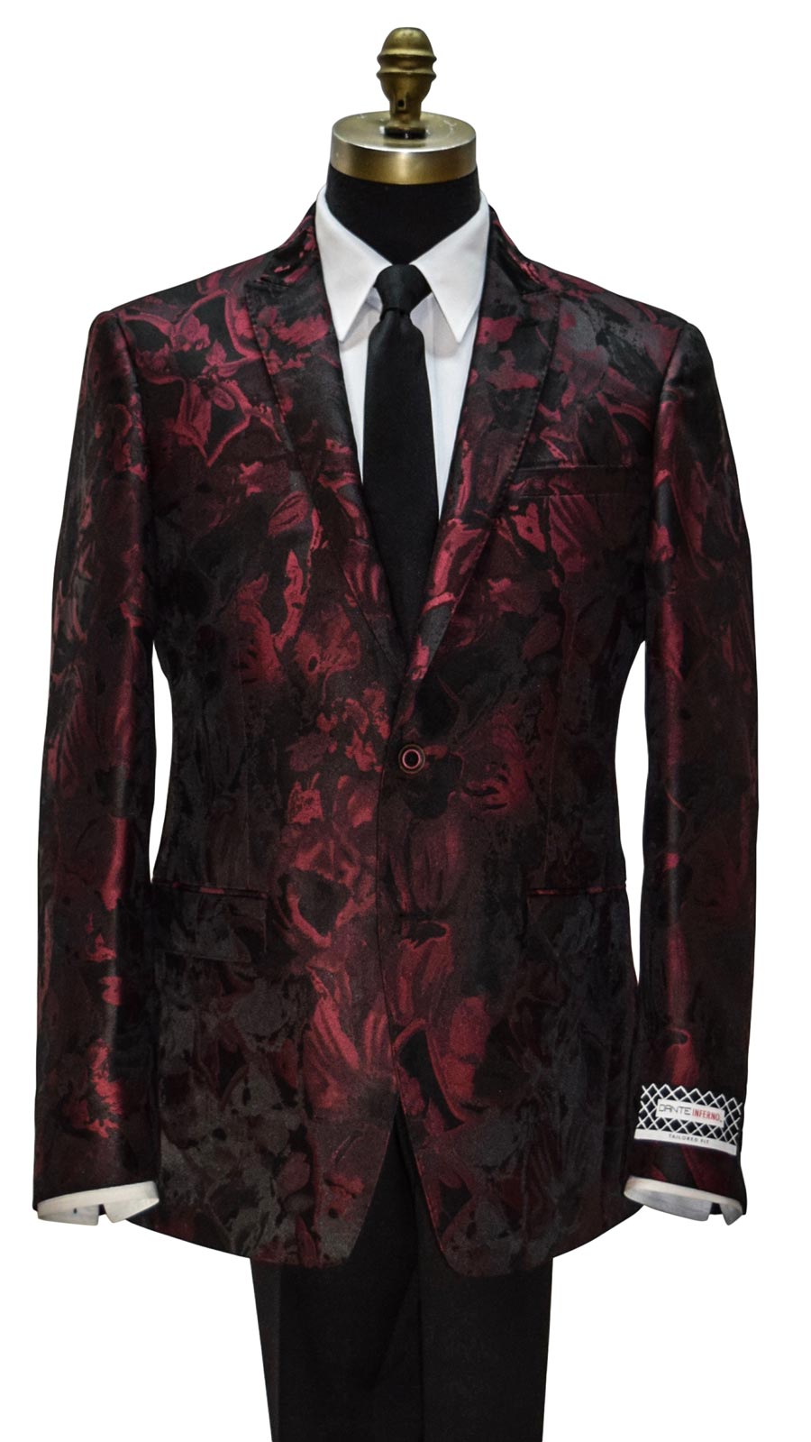Red and black patterned dinner jacket on a mannequin with a white shirt and long black dress tie.
