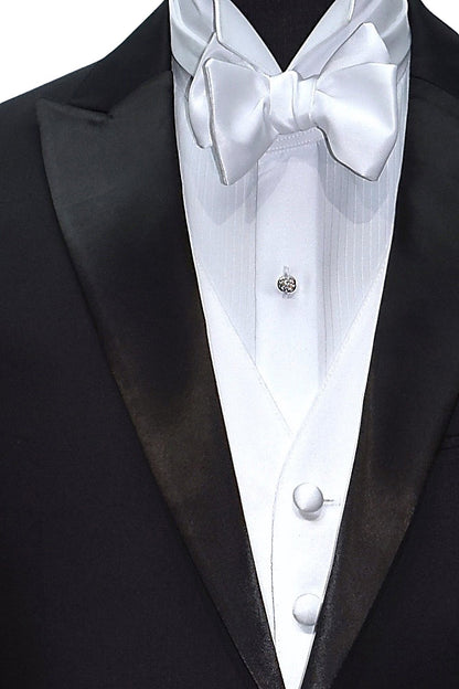 Close-up front view of black peak lapel tuxedo  with white satin vest and white "tie-yourself" bowtie. 