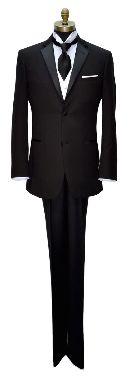 Full length mannequin of black slim-fit notch lapel tuxedo shown with white vest with long black satin dress tie