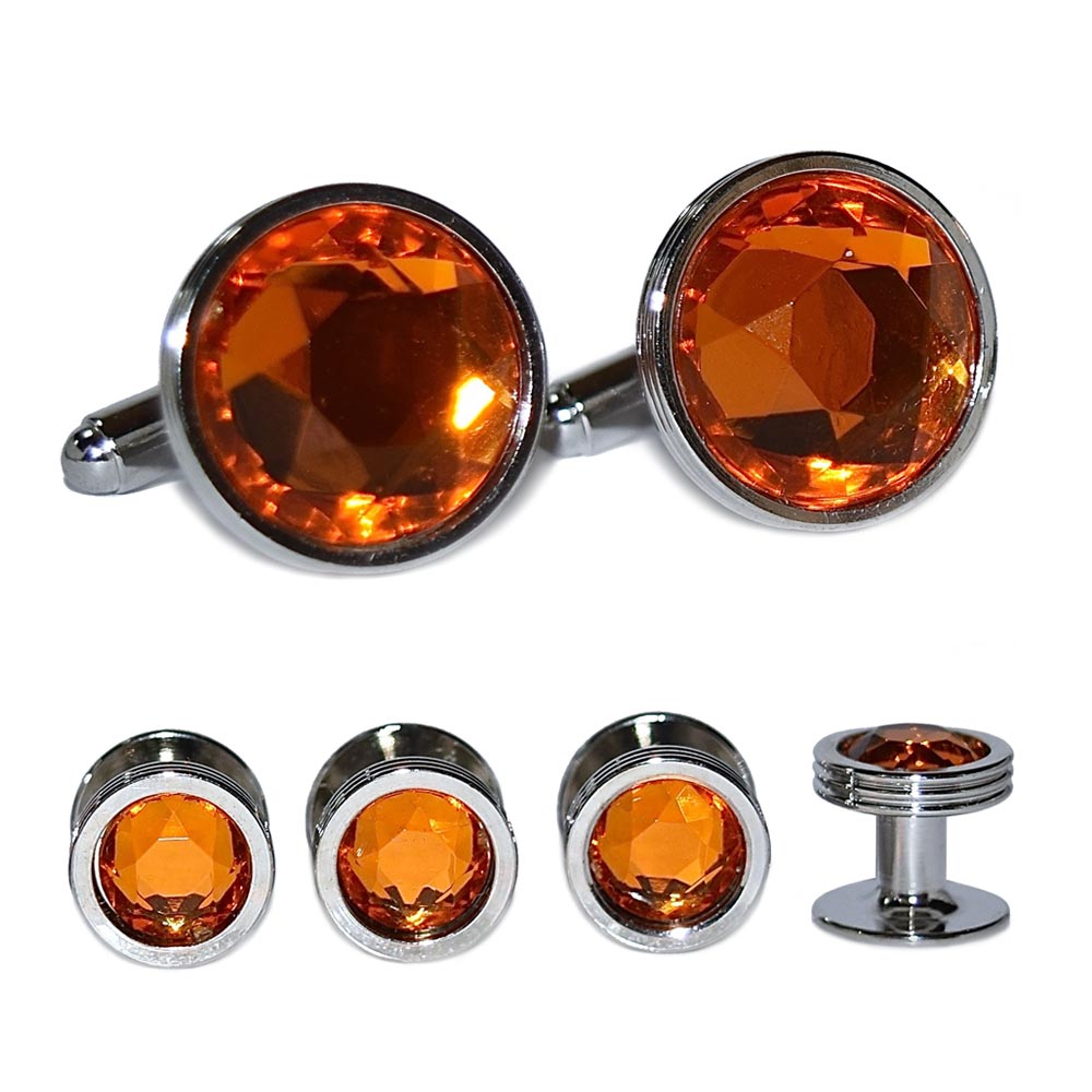 close-up Set of topaz orange gemstone cufflinks and studs on a white background