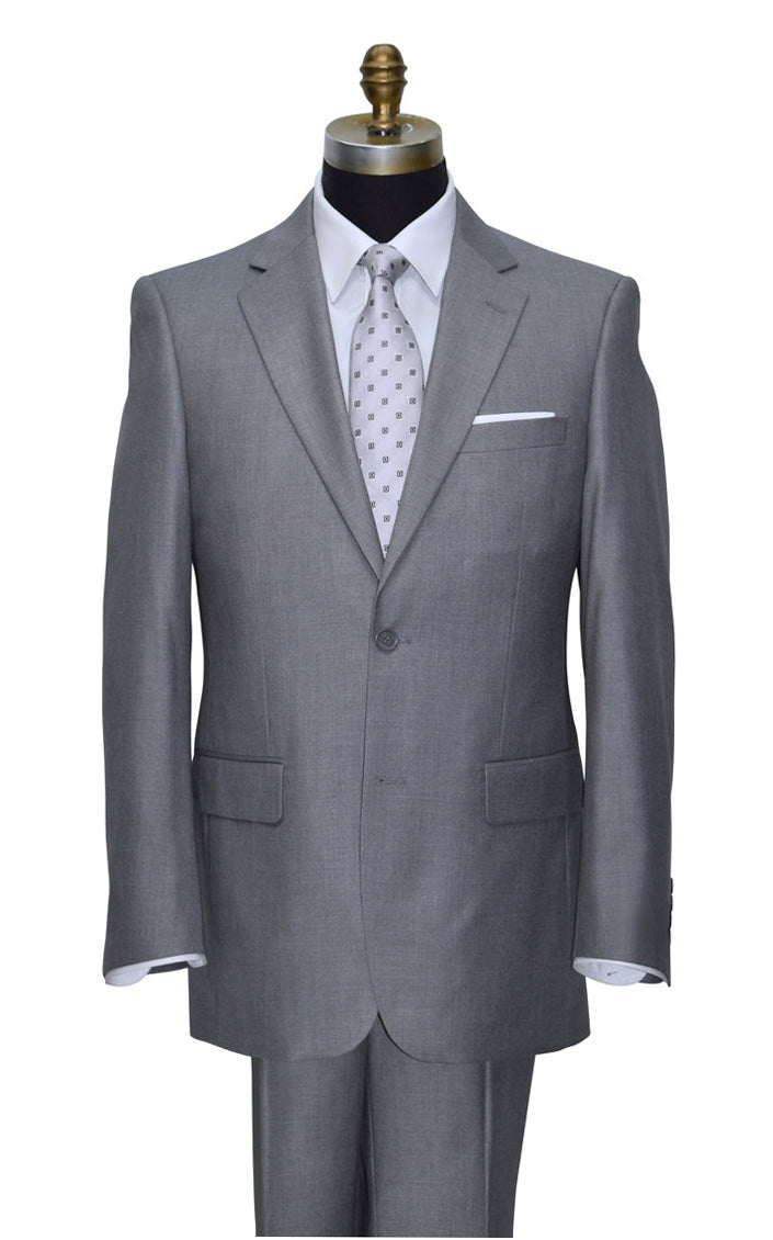 Close up of Gray suit on a mannequin with a white shirt and patterned tie against a white background