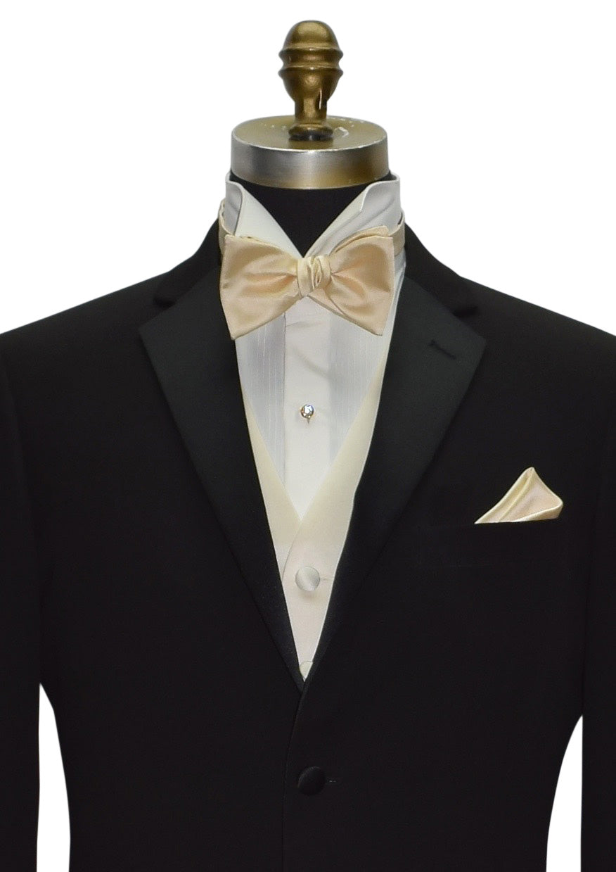 Close up of black slim notch lapel tuxedo with a Champagne "tie-yourself" bowtie and ivory satin vest. The shirt is an ivory wing collar tuxedo shirt.