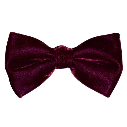 Burgundy velvet bow tie on a white background