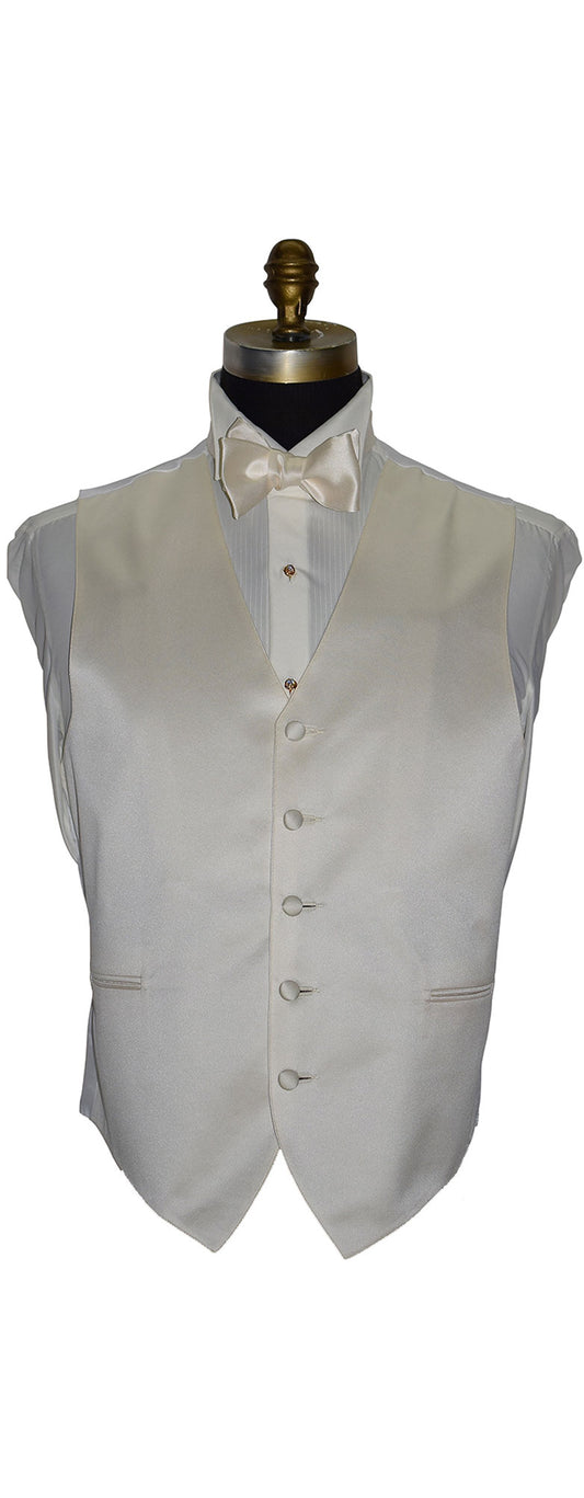 ivory satin tuxedo vest on a mannequin with a white shirt and ivory satin bow tie against a white background