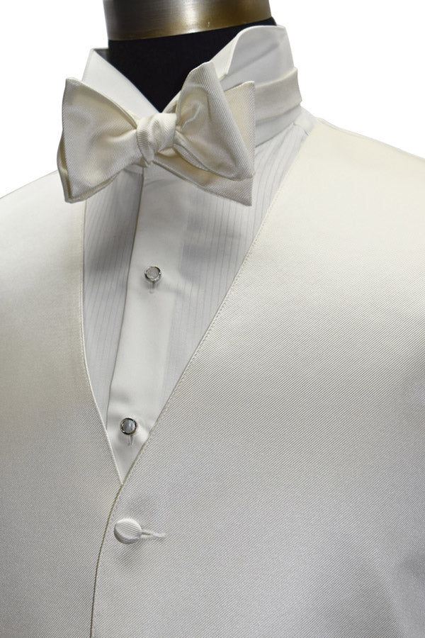 close-up side view - off-white tuxedo vest with an off-white "tie-yourself" bowtie on a mannequin against a hite background