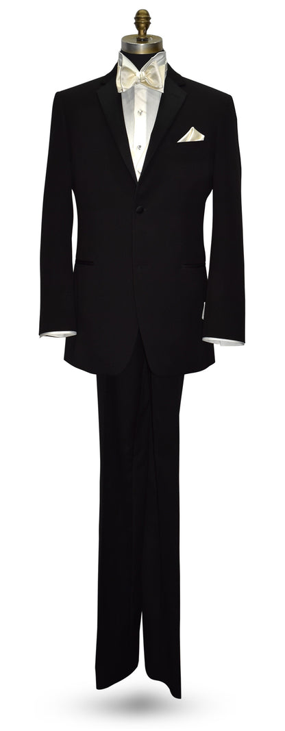 life size mannequin wearing a black notch-lapel tuxedo with an ivory tuxedo shirt and an off-white tuxedo vest and bowtie against a white background